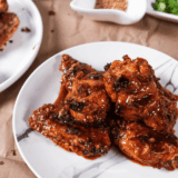 Plate of air fryer Jack Daniel's wings glazed in sticky whiskey BBQ sauce