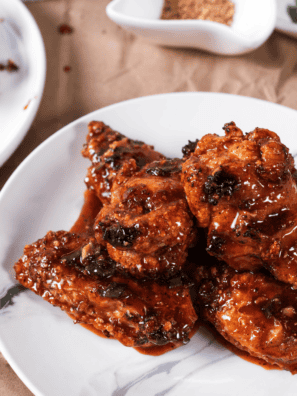 Plate of air fryer Jack Daniel's wings glazed in sticky whiskey BBQ sauce