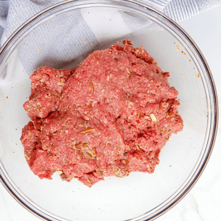 Bowl with ground beef and steak seasonings.