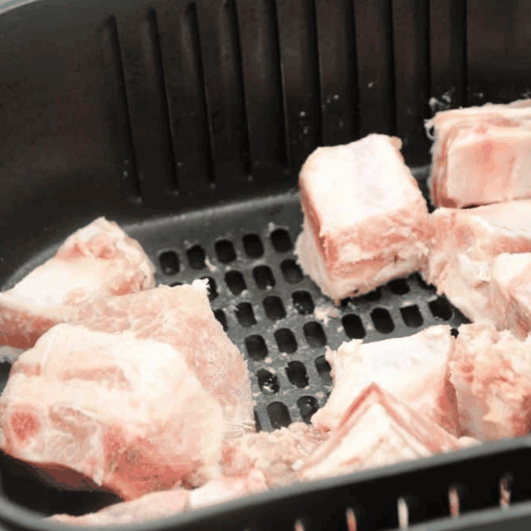 Place diced pork tips in the air fryer basket.