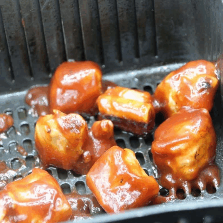 Return the sauced ribs to the air fryer and cook for an additional 4-6 minutes at 400°F.