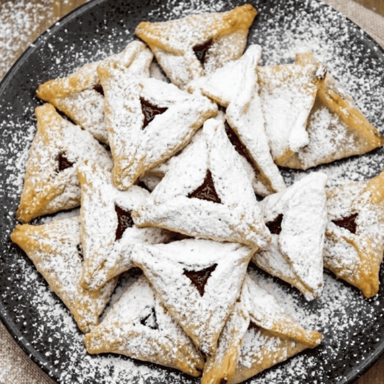 Air fryer raspberry wontons stacked on a serving plate with crisp golden wrappers and fruity filling.