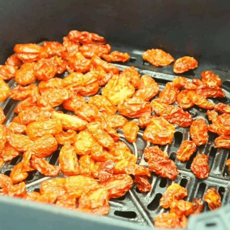 closeup: air fryer sun dried tomatoes in the air fryer basket