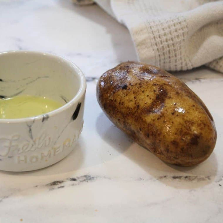 Ingredients for Salt potatoes on a table with potato and oil