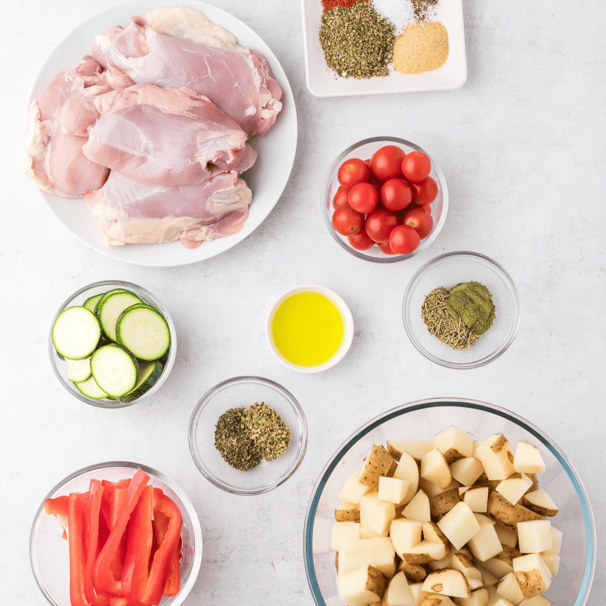 Ingredients needed for Air Fryer Tuscan Chicken Thighs on kitchen table.
