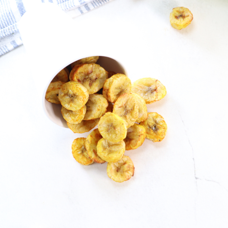 A bowl of crispy homemade air fryer banana chips, ready to enjoy as a healthy snack.