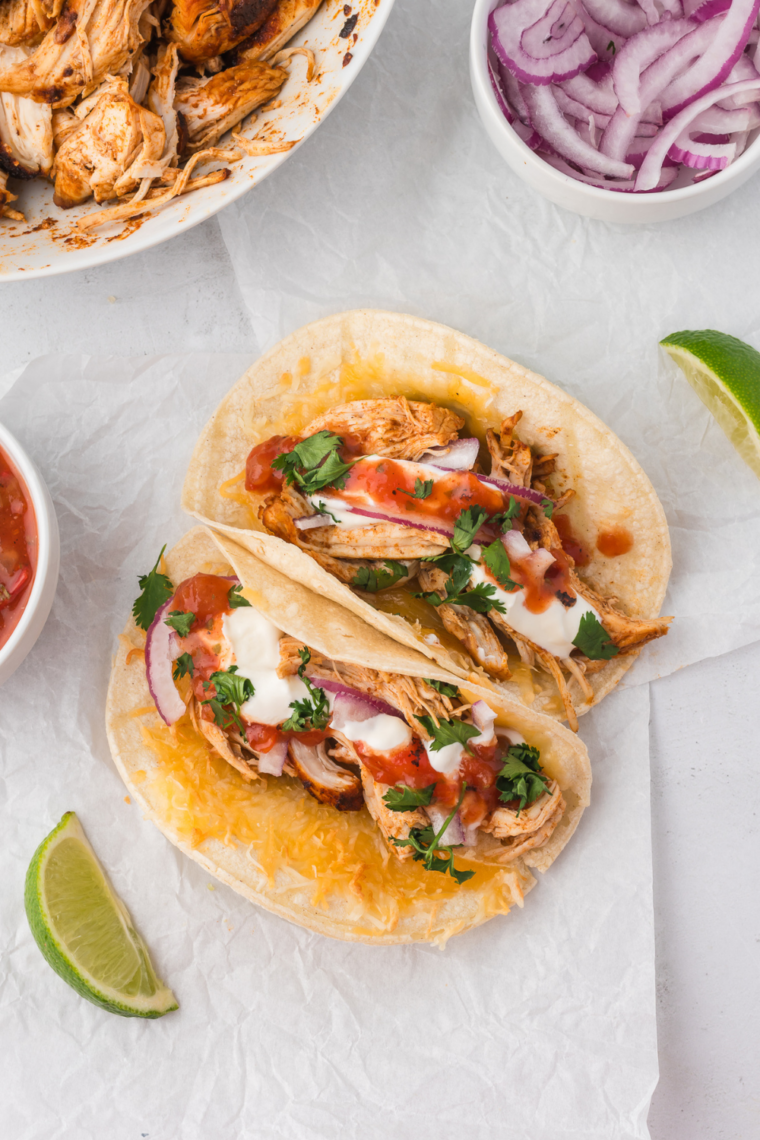 close-up of Blackstone mojo chicken tacos with juicy grilled chicken, cilantro, and street taco tortillas