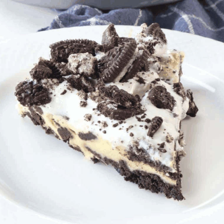 Slice of Copycat Cheesecake Factory Oreo Cheesecake with Oreo crust and creamy filling.