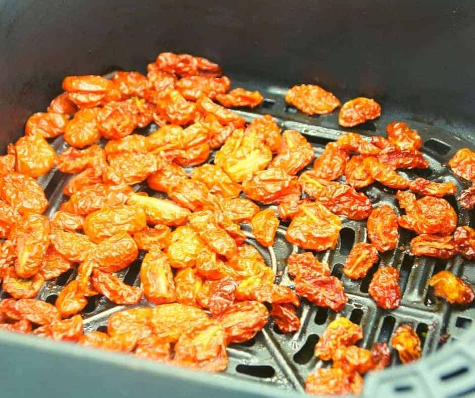 closeup: dehydrating tomatoes in air fryer basket