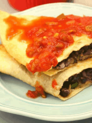 Crispy air fryer black bean quesadillas sliced and served on plate