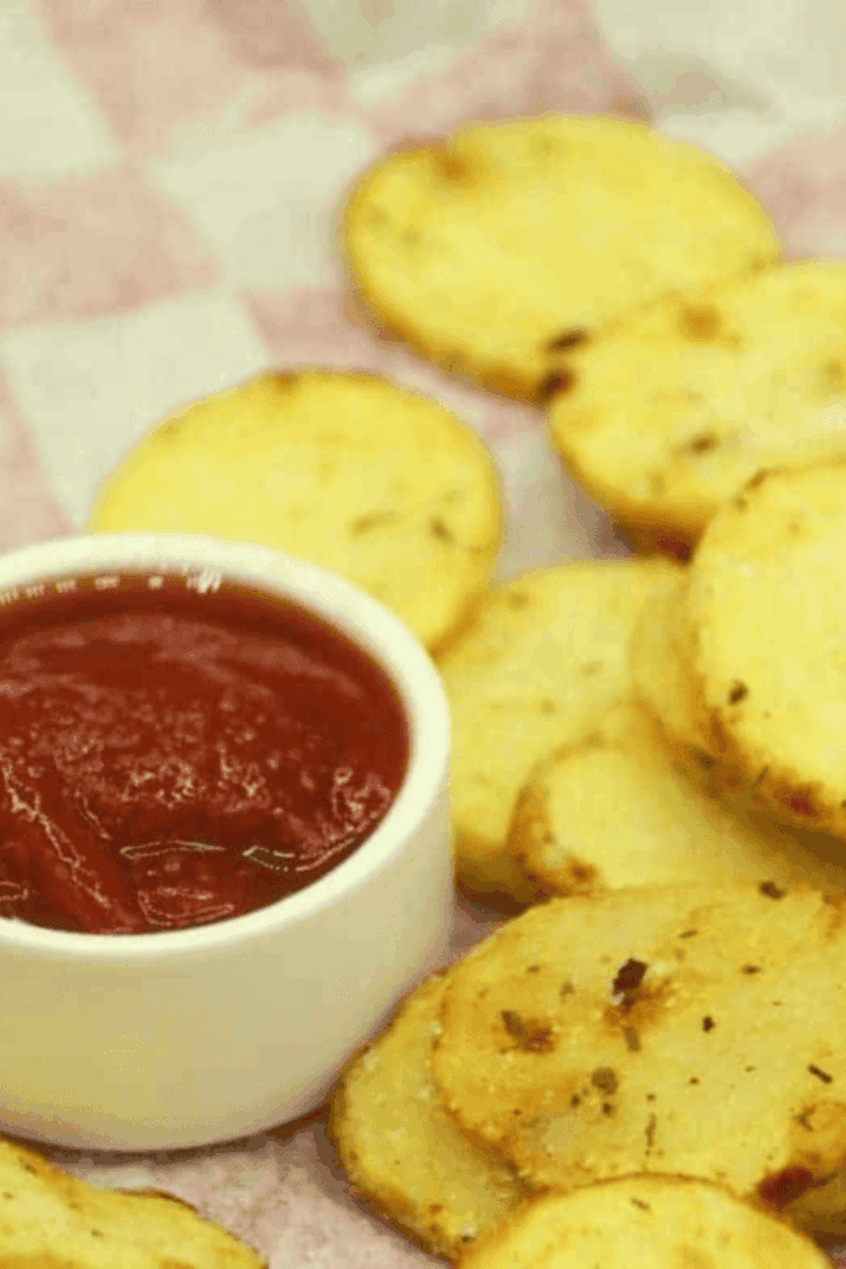 Crispy air fryer potato chips coated in zesty ranch seasoning, served in a bowl.