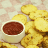 Golden, crispy air fryer potato chips coated in tangy ranch seasoning, served in a bowl.