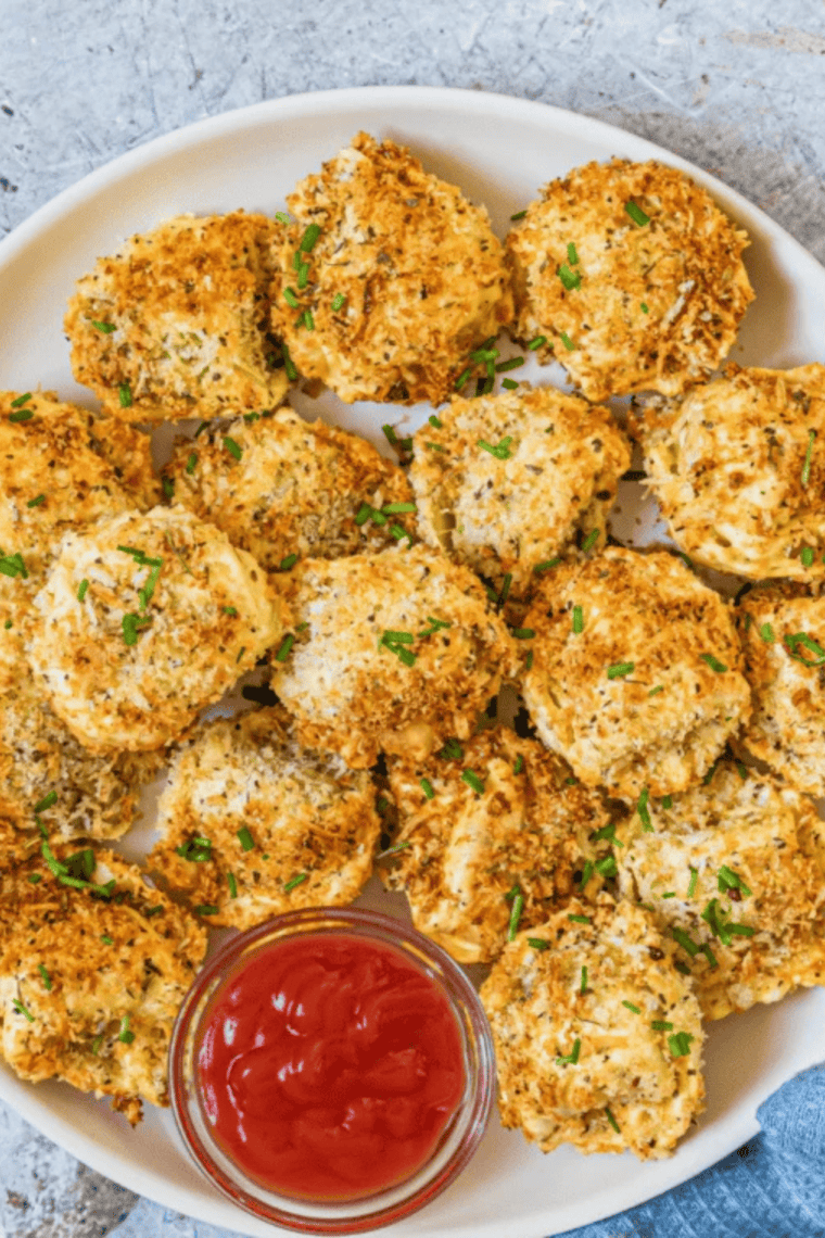 Crispy air fryer tortellini served on a plate with parmesan and herbs