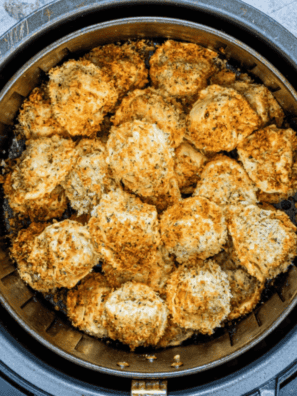Golden air fryer frozen tortellini in a bowl with marinara dipping sauce