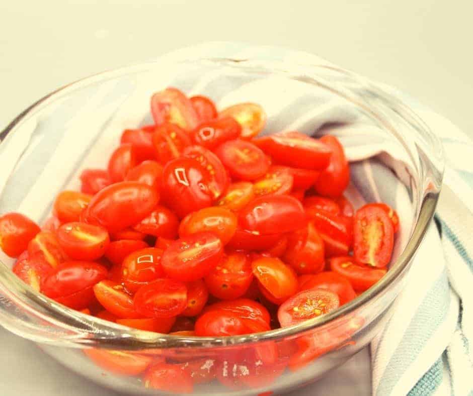 closeup: a bowl of halved tomatoes for sun dried tomatoes in air fryer