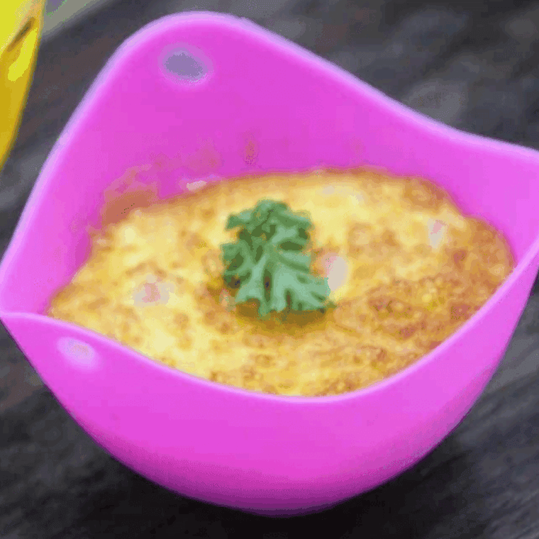 Starbucks-style Ham and Cheddar Sous Vide Egg Bites served on a plate, showcasing creamy texture and melted cheddar with ham pieces inside.