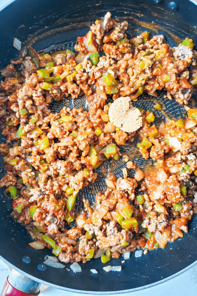 Mixing Heinz chili sauce, ketchup, mustard, and brown sugar into beef