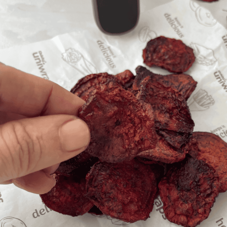 A plate of crispy, golden air fryer beet chips ready to enjoy.