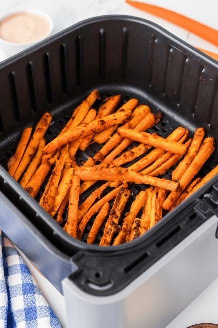 Golden, crispy air fryer carrot fries arranged in a single layer, ready to serve as a delicious side dish.