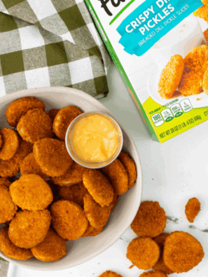 Air fryer basket filled with Farm Rich frozen fried pickles, golden and crispy, ready to serve.