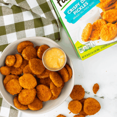 Air fryer basket filled with Farm Rich frozen fried pickles, golden and crispy, ready to serve.