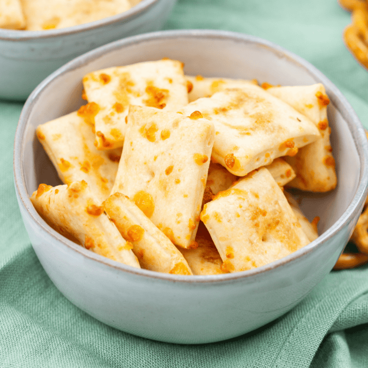 Homemade air fryer Cheez-Its piled in a white bowl, golden and crispy