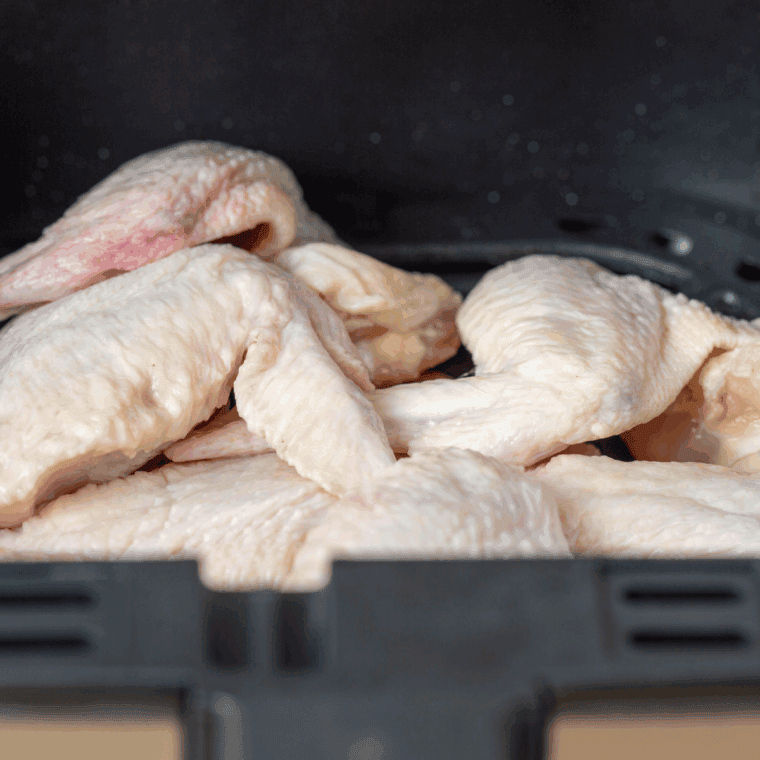 Place coated wings into the air fryer basket in a single layer.