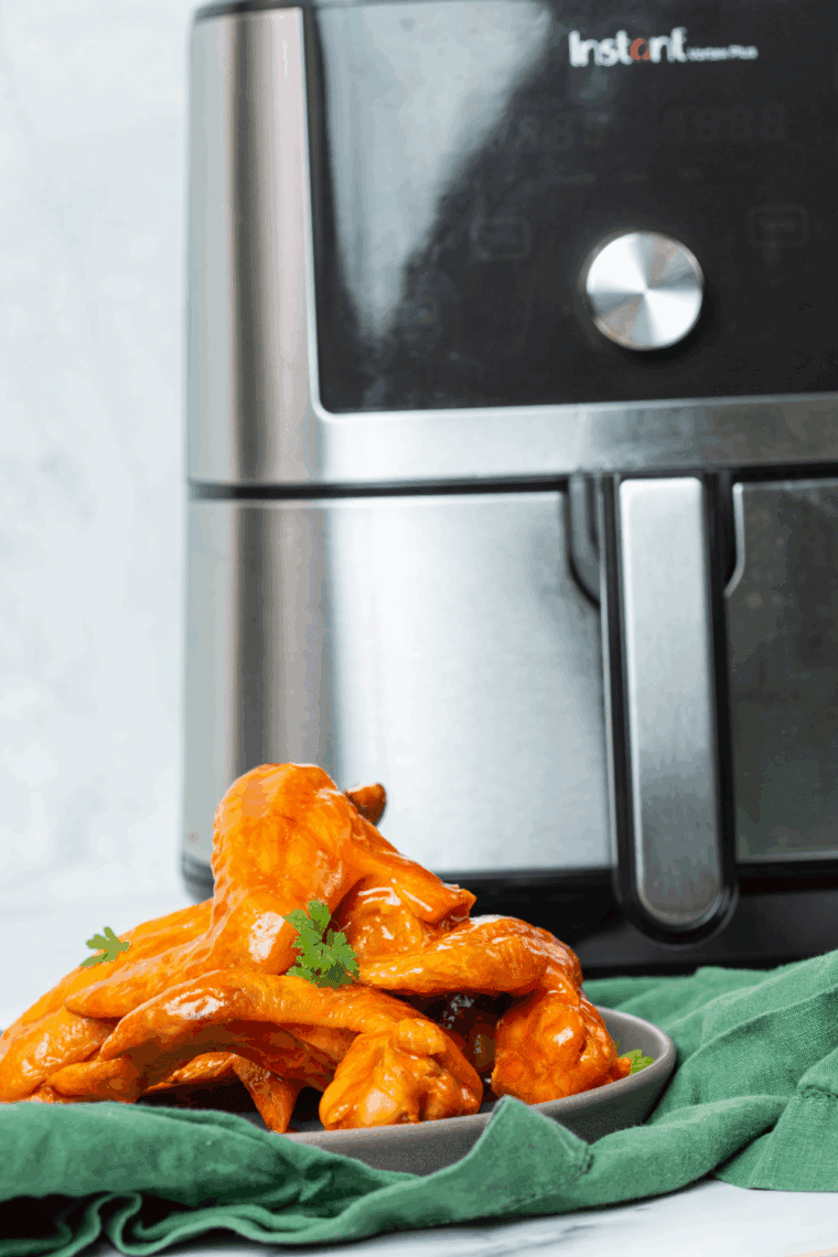 Crispy air fryer buffalo chicken wings coated in spicy Hooters-style sauce, served with celery sticks and ranch dipping sauce.