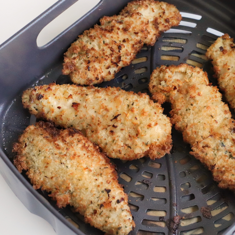 "Air Fried Italian Chicken Tenders plated with fresh herbs"