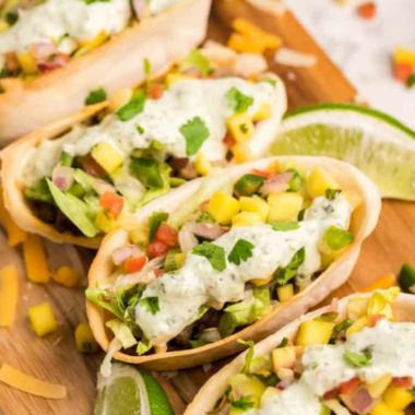 Air fryer mini taco boats filled with seasoned beef, cheese, lettuce, and pico de gallo