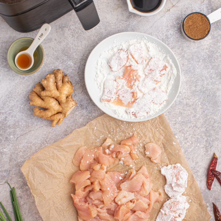 Chicken breasts rubbed with olive oil, seasoned with salt, and thinly sliced, then dredged in cornstarch.