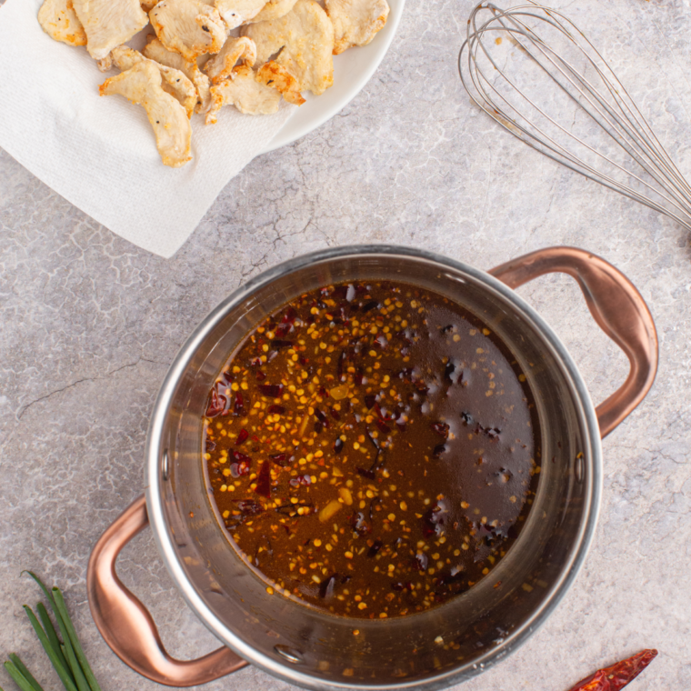 In a small saucepan, sauté ginger, garlic, and chili peppers, then add soy sauce, water, brown sugar, sesame oil, and cornstarch to thicken the sauce.