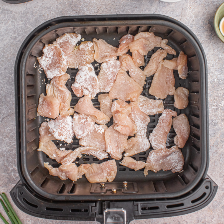 Chicken breasts rubbed with olive oil, seasoned with salt, and thinly sliced, then dredged in cornstarch.