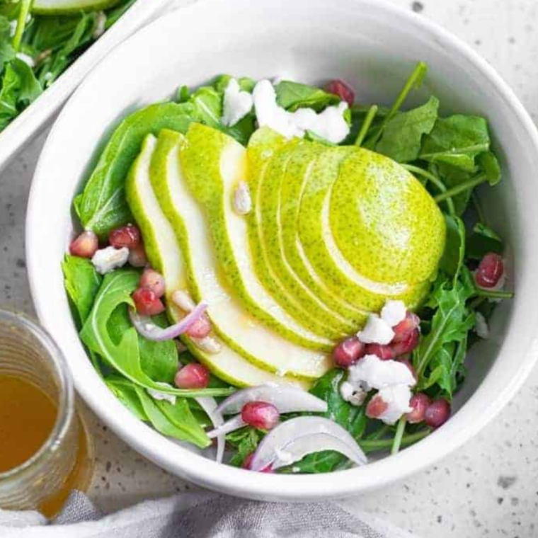 A vibrant plate of Air Fryer Roasted Pear Salad with caramelized pears, fresh greens, and crunchy nuts.