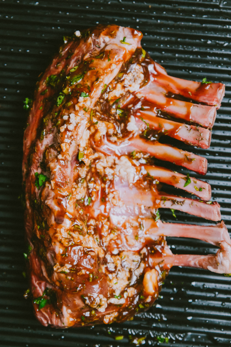 Lamb chops sizzling on a hot griddle, developing a deep golden-brown crust as they sear without being moved.