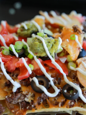 Loaded Blackstone Nachos made entirely on the griddle &mdash; crispy chips, seasoned beef, melty cheese, and all your favorite toppings. Ready in 20 minutes.