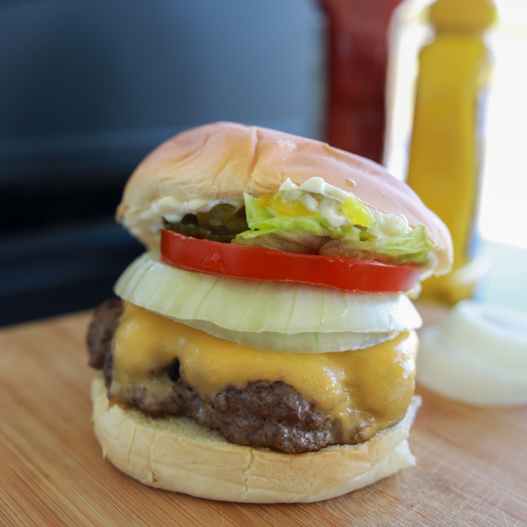 Double smash burger stacked with cheese, pickles, and toasted buns