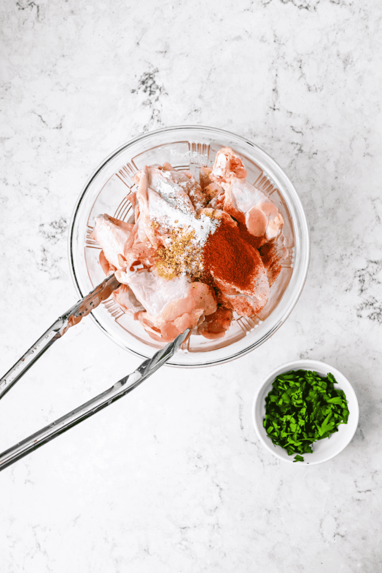 Patting chicken wings dry with paper towels for extra crispy results