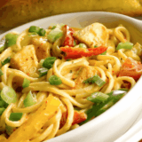 Instant Pot Chicken Fajita Pasta in a bowl with creamy sauce, sliced chicken, bell peppers, and pasta coated in fajita seasoning.