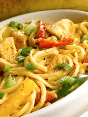 Instant Pot Chicken Fajita Pasta in a bowl with creamy sauce, sliced chicken, bell peppers, and pasta coated in fajita seasoning.