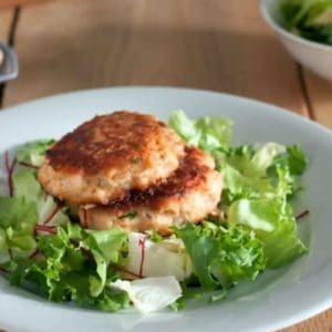 salmon patties on a bed of greens