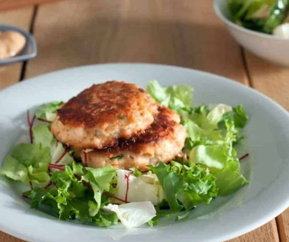 salmon patties on a bed of greens