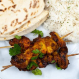 Serving air fryer tandoori chicken skewers with side dishes