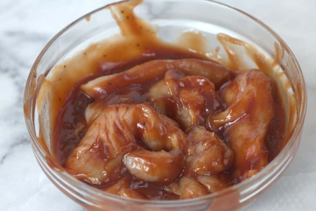 BBQ Chicken breast in a bowl marinating