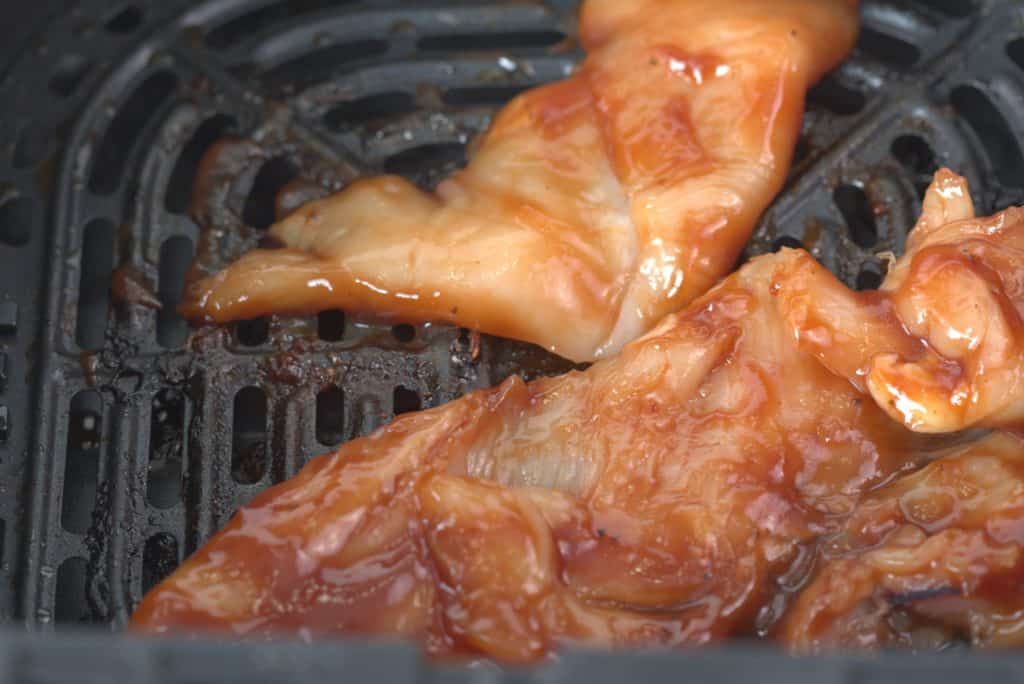 Step One: Spray your chicken with nonstick cooking spray, or brush with olive oil. Then add your seasonings to the chicken breast. 

Step Two: Add the seasoned chicken breasts to the air fryer basket, single layer, and set the cook time for 12-15 minutes, at 370 degrees f, using the air fryer setting. Flip halfway during the cooking process. Remove when the internal temperature reaches 164 degrees F.