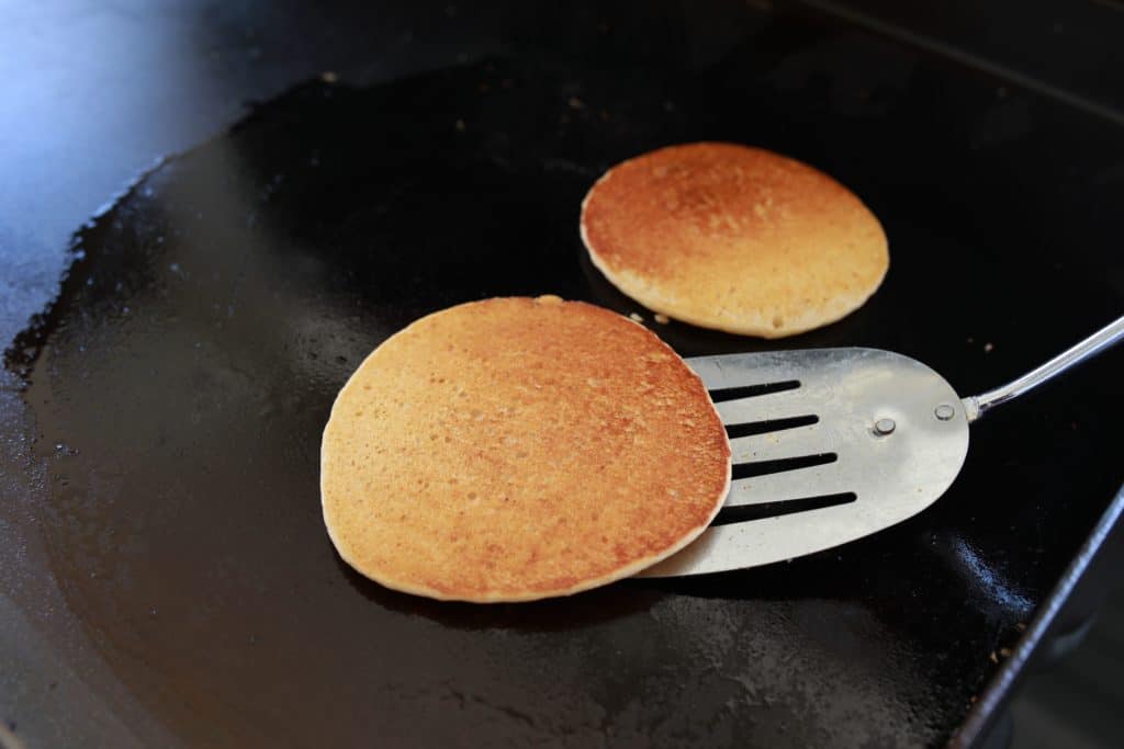 Blackstone Griddle Pancakes being flipped on the griddle
