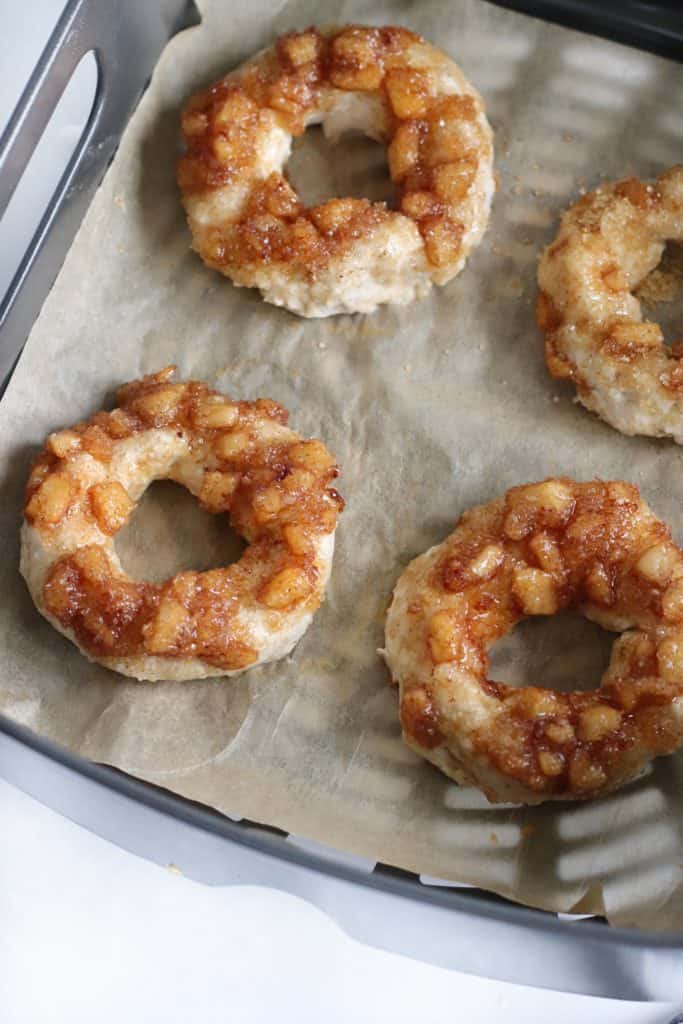 Place each finished bagel circle on to the parchment paper lined basket. Leaving about an inch to an inch and a half of space between each bagel. (I was able to fit about 4 bagels each time. You’ll probably need to do multiple batches.) Paint the bagels with the egg wash. Add about a ½ Tbsp of topping to each bagel. Cook the bagels for about 10 minutes. Once bagels are fully cooked remove them from the basket and place them on a cooling rack to cool for about eight minutes before serving.