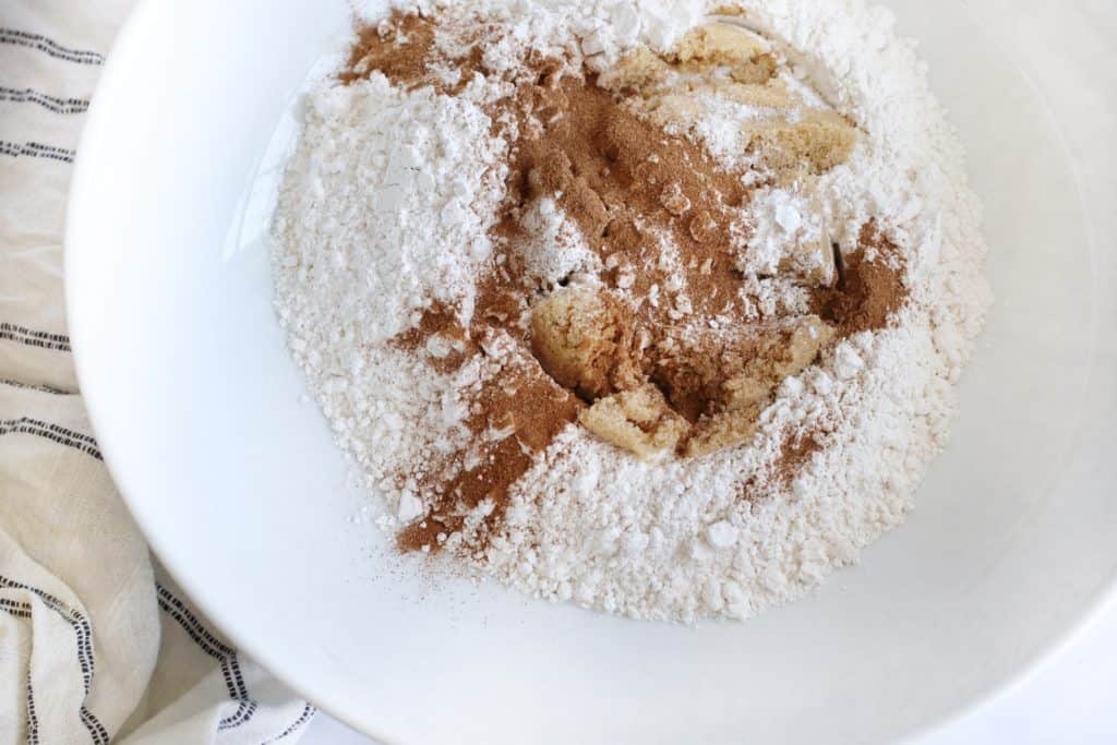 Flour, Sugar, and other ingredients a large white bowl.
