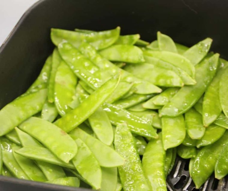 closeup: sugar snap peas in air fryer basket