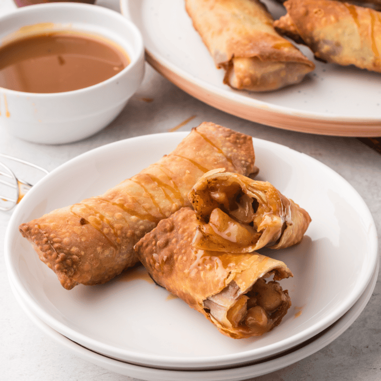 Air Fryer Apple Pie Egg Rolls golden and crispy, filled with spiced apple filling and served with a caramel drizzle.